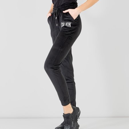 Czarne damskie spodnie dresowe ze srebrnym napisem - Odzież
