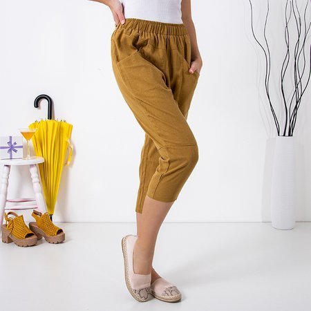 Musztardowe damskie spodnie o długości 3/4 - Odzież
