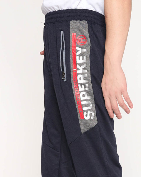 Granatowe męskie spodnie dresowe z napisami - Odzież