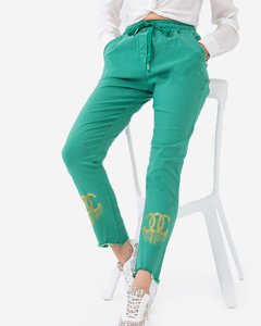 Зелені тканинні жіночі штани з фіанітами - Одяг
